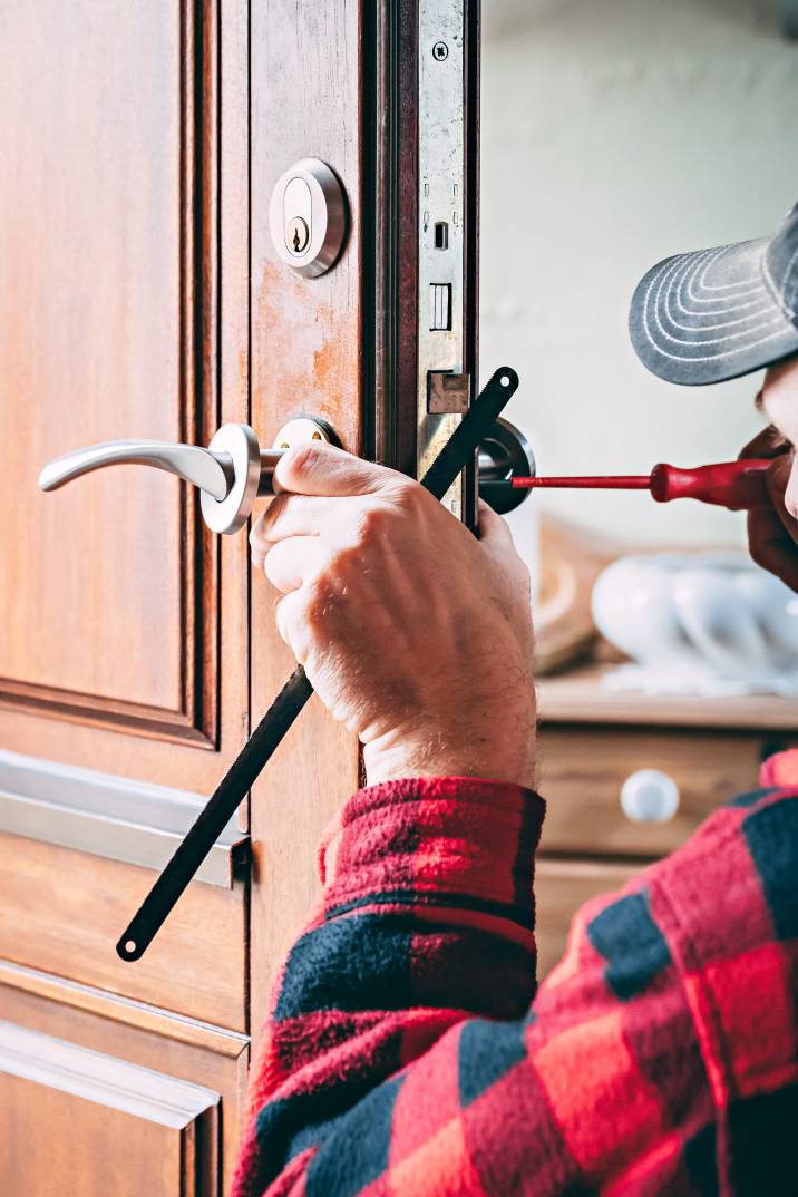 a handyman repairing a doorknob