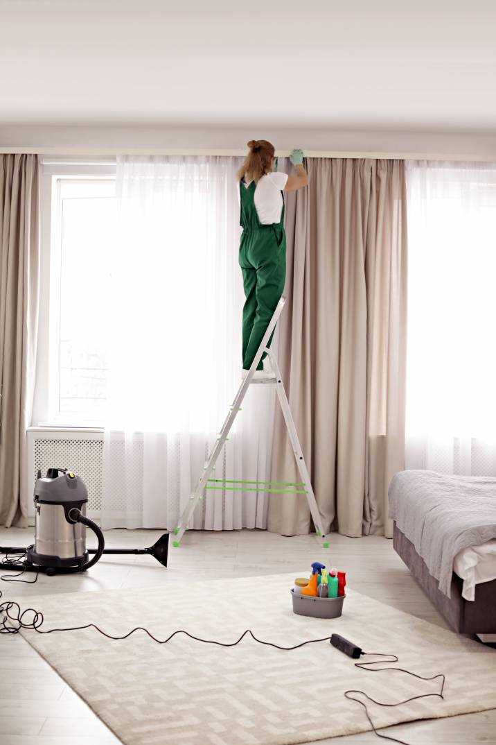 a woman cleaning an Airbnb