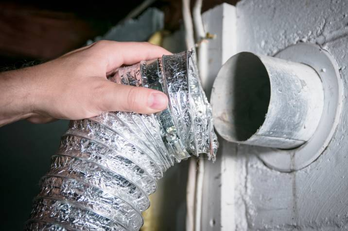 removing a dryer vent hose for cleaning and maintenance