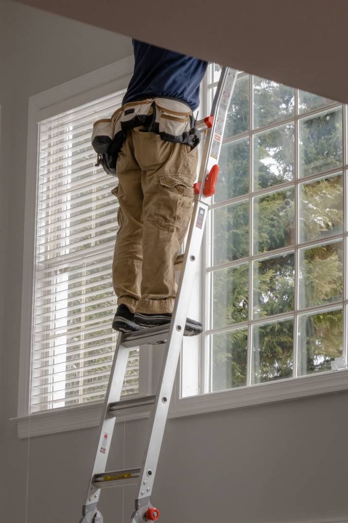 a man installing blinds
