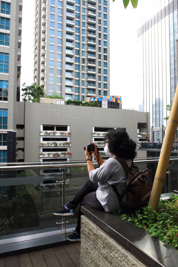 a woman taking photos of building exteriors