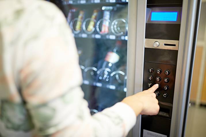 a woman using a vending machine